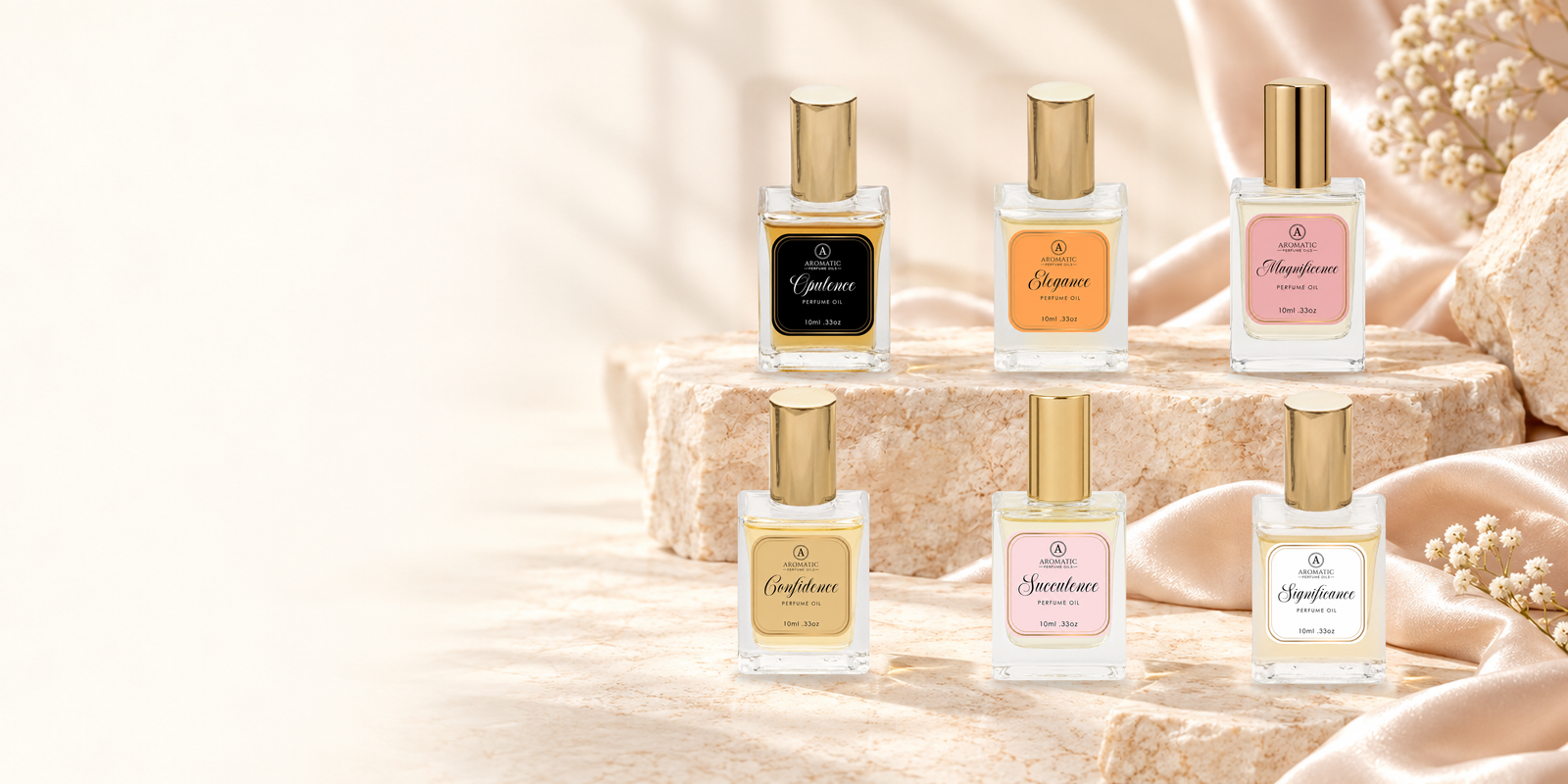 Six Aromatic Perfume Oils fragrances on warm ivory stone with blush fabric.